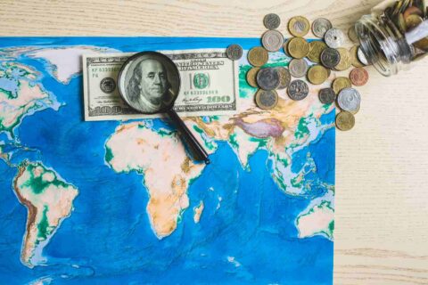 map-world-with-money-magnifying-glass (1)